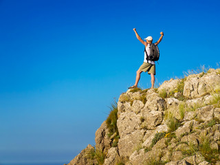 Tourist on the rock. Sport and active life concept