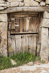 Old wood door and stone wall