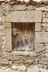 Old wood door and stone wall