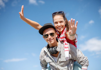 smiling teenagers in sunglasses having fun outside