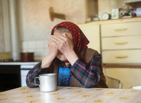 Old Sad Woman In The Kitchen