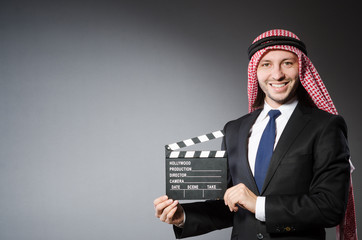  Arab man with movie clapper isolated on white