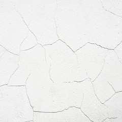 Cracked surface of white wall