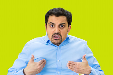 Angry man asking you mean ME? isolated on green background