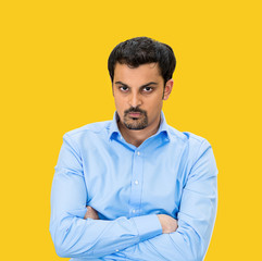 Portrait of Grumpy, difficult young man on yellow background 