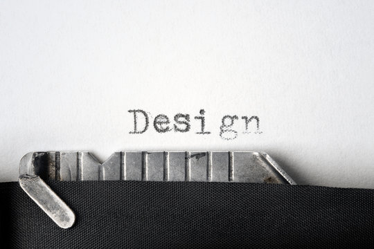 "Design" written on an old typewriter. Closeup.