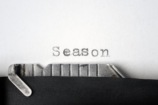 "Season" written on an old typewriter. Closeup.