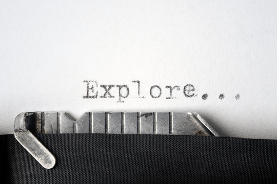 "Explore..." written on an old typewriter. Closeup.