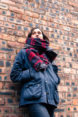 Model wearing tartan scarf and barbour style jacket