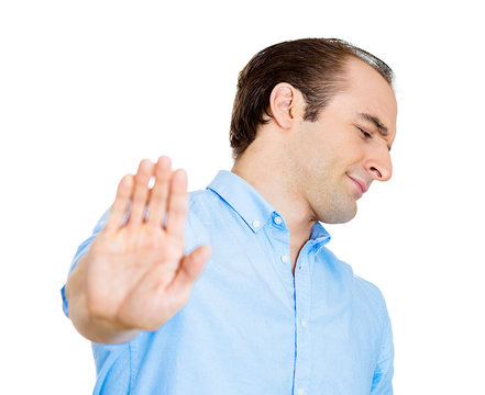 Offended man gives talk to the hand gesture on white background