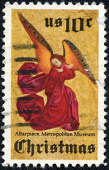 angel in red gown against golden back ground