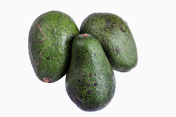three whole avocatto on a white background