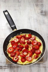 Strawberry omelette on frying pan