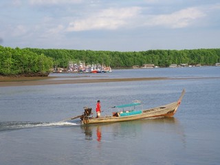 Sailing long-tailed boat on a river in Thailand