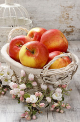 Wicker basket of fresh red ripe apples.