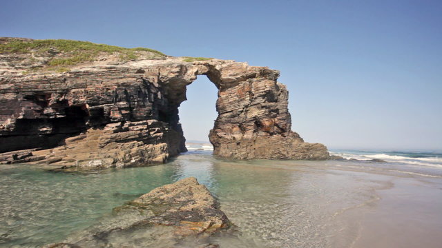 Stone arches on Playa de las Catedrales during outflow, Spain