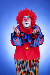 Clown men in red costume on blue background