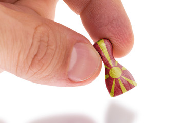 Hand holding wooden pawn, flag painting, selective focus