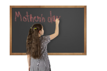 School girl writing on chalkboard