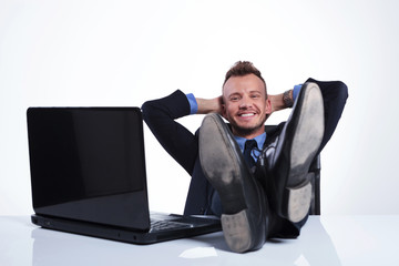 business man with hands behind head