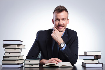 pensive business man among books