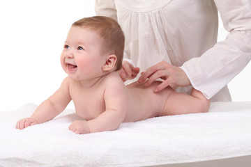 Baby massage. Mother massaging kid