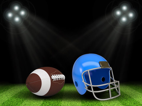 Football ball and helmet in the middle of field