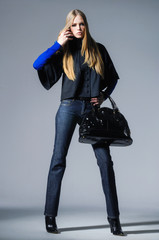 full-length fashion girl with handbag posing