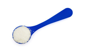 powdered milk in a blue spoon on white with clipping path