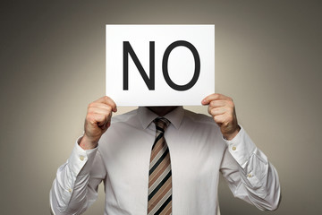 Man holding Label with NO