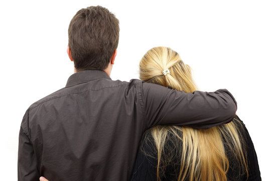 Back view of young couple (man and woman) hug