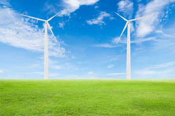 Fototapeta premium wind turbine on green grass with blue sky