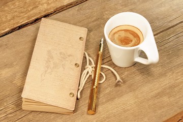 Obraz na płótnie Canvas Vintage Notepad, Golden Fountain Pen and Cup of Espresso on Wood