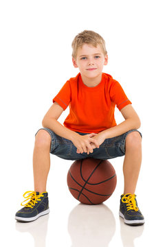 Kid Sitting On A Basketball