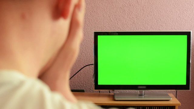 Man watches TV(television) - green screen - sad man