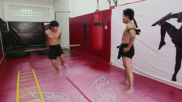 16of20 Asian man training kickboxing in gym as fighter