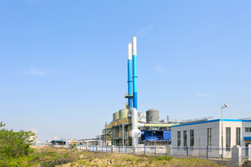 coal fired power station with cooling towers releasing steam int
