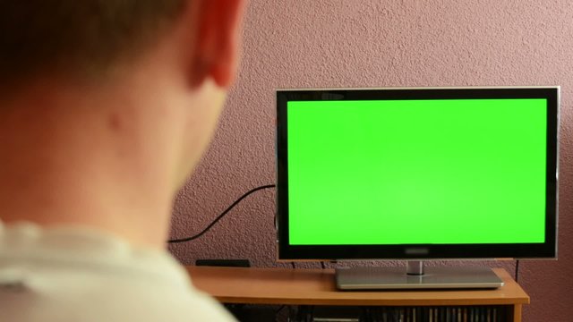 Man watches TV(television) - green screen - man drinks tea