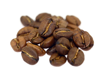 heap of brown coffee beans isolated on white background