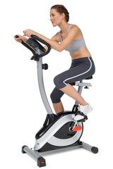 Side view of a beautiful woman on stationary bike