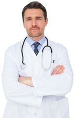 Fototapeta premium Handsome young doctor with arms crossed