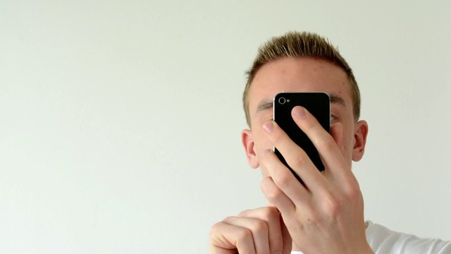 man takes pictures with a smartphone