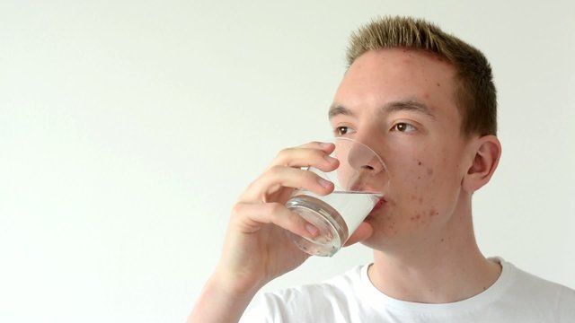 man drinks water and smiles - isolated