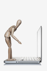 Manikin standing on a laptop computer