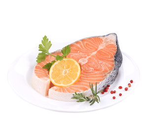 Raw salmon steak with lemon.