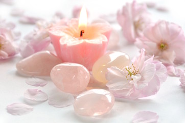 gemstones with candle and flowers