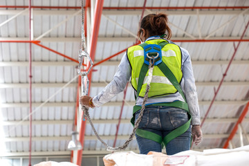 Warehouse worker with safety harness secuerity for fall protecti