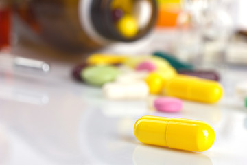 yellow capsule and different medicaments