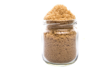 Brown sugar in a glass container over white background