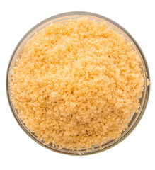 Brown sugar in a glass container over white background